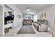 Bright living room with gray reclining sofas and tile floors at 410 Pine Pointe Ct, Seffner, FL 33584