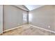 Cozy bedroom features neutral paint, carpet floors, a window with blinds, and electrical outlets on each wall at 4317 Knollcrest Ct, Spring Hill, FL 34609