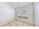 Cozy dining area featuring a window, tile floor and a stylish chandelier at 4317 Knollcrest Ct, Spring Hill, FL 34609