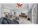 Open-concept living room with high ceilings, comfortable seating, dining area and access to a large sliding glass door at 4317 Knollcrest Ct, Spring Hill, FL 34609
