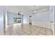 Spacious living room with tile flooring, sliding glass doors, and a ceiling fan at 4317 Knollcrest Ct, Spring Hill, FL 34609
