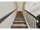 Modern staircase with neutral carpeting and dark wood railing at 4909 4Th N Ave, St Petersburg, FL 33710