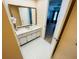 Bathroom with vanity, large mirror, and tiled floors at 4950 Gulf Blvd # 401, St Pete Beach, FL 33706