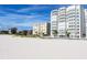 Beachfront view of luxurious high rise building and beach at 4950 Gulf Blvd # 401, St Pete Beach, FL 33706