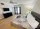 Bright bedroom featuring a king-size bed and hardwood floors at 4950 Gulf Blvd # 401, St Pete Beach, FL 33706
