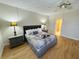 King-size bed, nightstands, and ceiling fan in bedroom at 4950 Gulf Blvd # 401, St Pete Beach, FL 33706