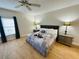 King-size bed, nightstands, ceiling fan, and wood floors at 4950 Gulf Blvd # 401, St Pete Beach, FL 33706