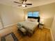 King-size bed, hardwood floors, and ceiling fan in the bedroom at 4950 Gulf Blvd # 401, St Pete Beach, FL 33706