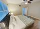 King-size bed, nightstands, ceiling fan in bright bedroom at 4950 Gulf Blvd # 401, St Pete Beach, FL 33706