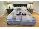 King-size bed, nightstands, ceiling fan in cozy bedroom at 4950 Gulf Blvd # 401, St Pete Beach, FL 33706