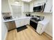Modern kitchen with stainless steel appliances and white cabinetry at 4950 Gulf Blvd # 401, St Pete Beach, FL 33706