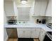 Updated kitchen with stainless steel appliances and white cabinets at 4950 Gulf Blvd # 401, St Pete Beach, FL 33706