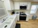 Modern kitchen with stainless steel appliances and white cabinetry at 4950 Gulf Blvd # 401, St Pete Beach, FL 33706