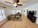 Spacious living room featuring hardwood floors and a ceiling fan at 4950 Gulf Blvd # 401, St Pete Beach, FL 33706
