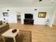 Open living room showcasing hardwood floors and a view into the bedroom at 4950 Gulf Blvd # 401, St Pete Beach, FL 33706