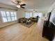 Bright living room with hardwood floors, comfy sofas, and ceiling fans at 4950 Gulf Blvd # 401, St Pete Beach, FL 33706