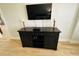 Living room with media console and mounted TV at 4950 Gulf Blvd # 401, St Pete Beach, FL 33706