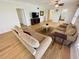 Hardwood floor living room with sofas and a view to kitchen at 4950 Gulf Blvd # 401, St Pete Beach, FL 33706