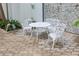 White metal patio furniture set on a stone patio at 4950 Gulf Blvd # 401, St Pete Beach, FL 33706