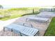 Outdoor patio with comfortable lounge chairs near the beach at 4950 Gulf Blvd # 401, St Pete Beach, FL 33706