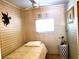 Small bedroom with a twin bed and patterned wallpaper at 5335 Fairfield S Ave # 78, Gulfport, FL 33707
