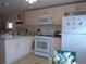 White kitchen with ample cabinetry and appliances at 5335 Fairfield S Ave # 78, Gulfport, FL 33707