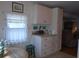 Kitchen with white cabinets, countertops, and a window at 5335 Fairfield S Ave # 78, Gulfport, FL 33707