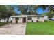 House exterior with a well-maintained lawn at 6145 55Th N Ave, St Petersburg, FL 33709