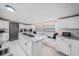 Modern kitchen with white cabinets, granite island, and stainless steel appliances at 6145 55Th N Ave, St Petersburg, FL 33709