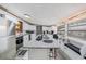 Modern kitchen featuring white cabinets, granite island, and stainless steel appliances at 6145 55Th N Ave, St Petersburg, FL 33709