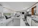 Modern kitchen with white cabinets, granite island, and stainless steel appliances at 6145 55Th N Ave, St Petersburg, FL 33709