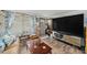 Comfortable living room with hardwood floors, a brown couch, and a large TV at 6145 55Th N Ave, St Petersburg, FL 33709