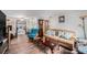 Cozy living room featuring hardwood floors, brown couch, and a large TV at 6145 55Th N Ave, St Petersburg, FL 33709