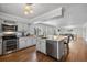 Spacious kitchen with island, stainless steel appliances, and hardwood floors at 7418 Bay Dr, Tampa, FL 33635