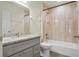 Updated bathroom with gray vanity, granite countertop, and beige tile shower/tub combo at 806 E Laura St, Plant City, FL 33563
