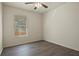 Bright bedroom with wood-look flooring and window with blinds at 806 E Laura St, Plant City, FL 33563