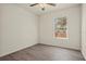 Spacious bedroom with wood-look flooring and a window with blinds at 806 E Laura St, Plant City, FL 33563