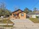 Newly constructed home with brown and tan exterior, a driveway, and a small yard at 806 E Laura St, Plant City, FL 33563
