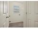 Small laundry room with window, shelving and vinyl flooring at 806 E Laura St, Plant City, FL 33563