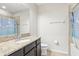 Bathroom with tub, shower, granite vanity, and updated fixtures at 8836 Citrus Palm Dr, Tampa, FL 33626