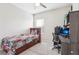 Bedroom with full-size bed, built-in shelving, and workspace at 8836 Citrus Palm Dr, Tampa, FL 33626
