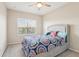 Bright bedroom with a queen-size bed and patterned bedding at 8836 Citrus Palm Dr, Tampa, FL 33626