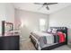 Bedroom with a king-size bed, dresser, and window coverings at 8836 Citrus Palm Dr, Tampa, FL 33626