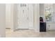 Bright entryway with white door, tile floor, and mini-fridge at 8836 Citrus Palm Dr, Tampa, FL 33626