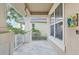 Covered front porch with tiled flooring, white railing, and a window at 8836 Citrus Palm Dr, Tampa, FL 33626