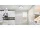 Modern kitchen with white cabinets, mosaic backsplash, and island at 8836 Citrus Palm Dr, Tampa, FL 33626