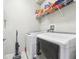 Laundry room with washer, dryer, and shelving for storage at 8836 Citrus Palm Dr, Tampa, FL 33626