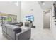 Spacious living room with gray sectional sofa, large TV, and high ceilings at 8836 Citrus Palm Dr, Tampa, FL 33626