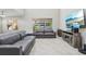 Spacious living room featuring a large TV and comfortable seating at 8836 Citrus Palm Dr, Tampa, FL 33626
