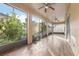 Spacious screened porch with tile flooring and ceiling fan, overlooking backyard at 8836 Citrus Palm Dr, Tampa, FL 33626